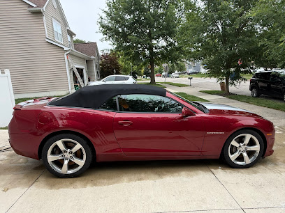 Candy-red Camaro convertible gleaming in a driveway after an A & A Showroom Shine detail